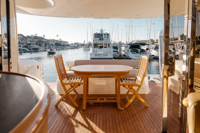 A table and chairs on a boat in the water